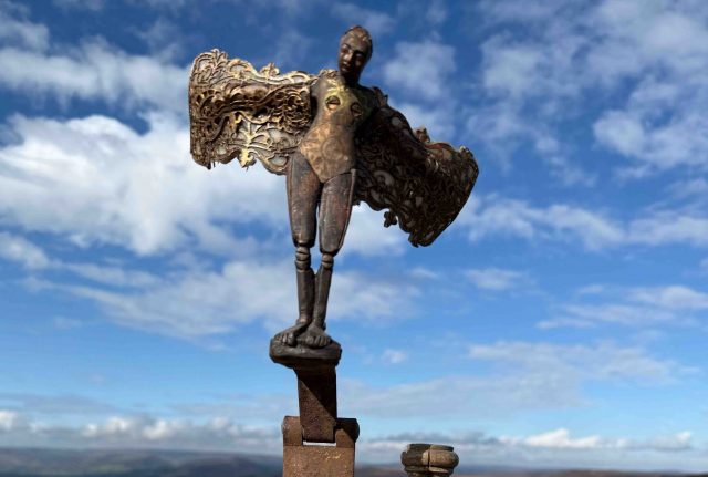 Constructed from reclaimed wood and polymer clay, The <em>Angel of Sheffield s</em>tands ready to take flight over the factory chimneys tops. The Angel of Sheffield